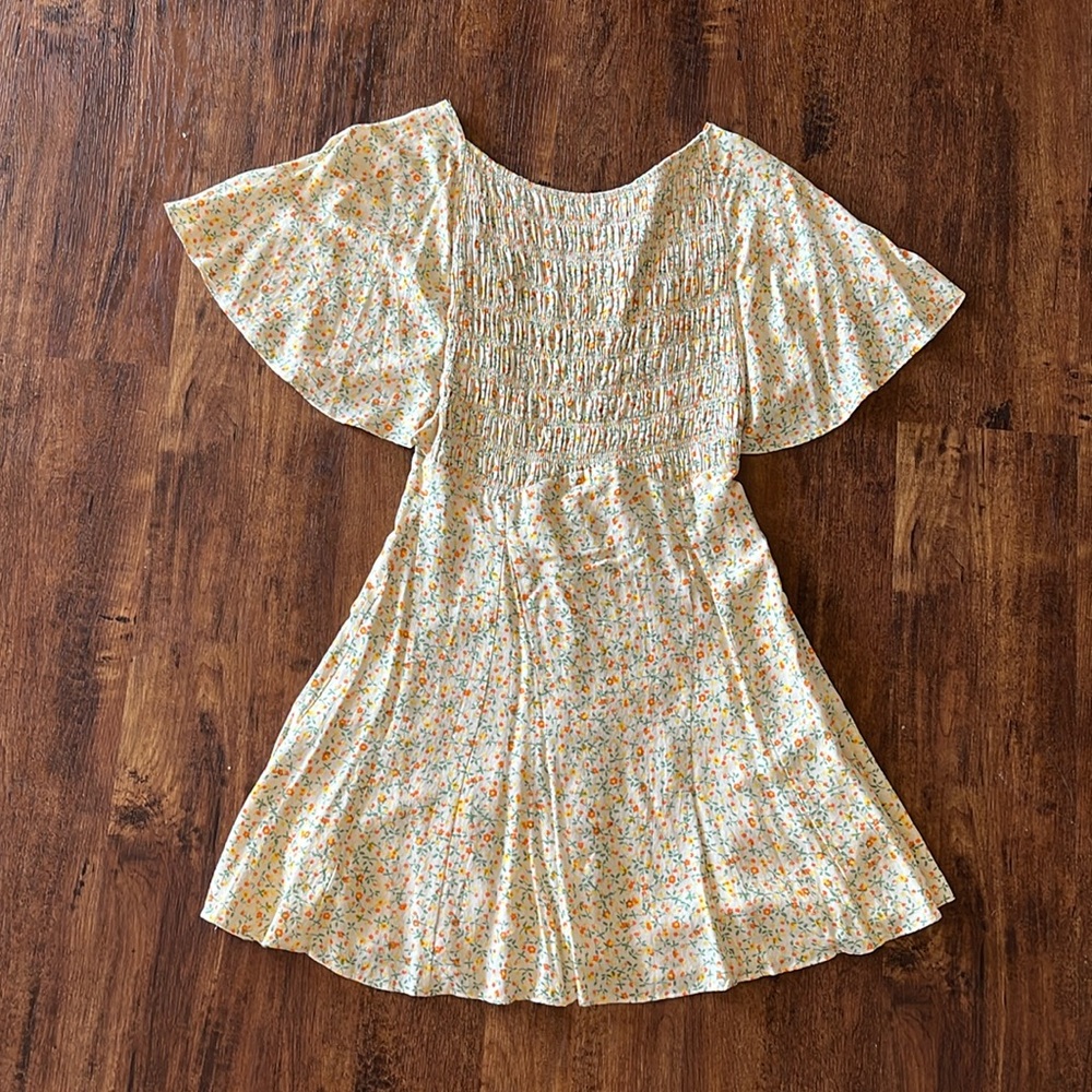 FREE PEOPLE// yellow floral mini dress with open corsette back & flutter sleeves
